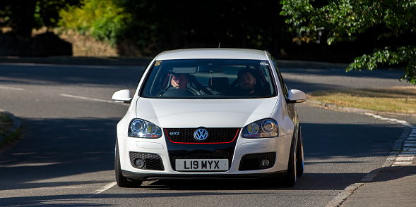Turvey, Beds, UK - July 16th 2022. 2008 1984 cc Volkswagen Golf gti car driving on an English country road