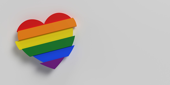 New redesigned LGBTQ pride flag background. Rainbow Printed cardboard with die-cut heart shape. Top view