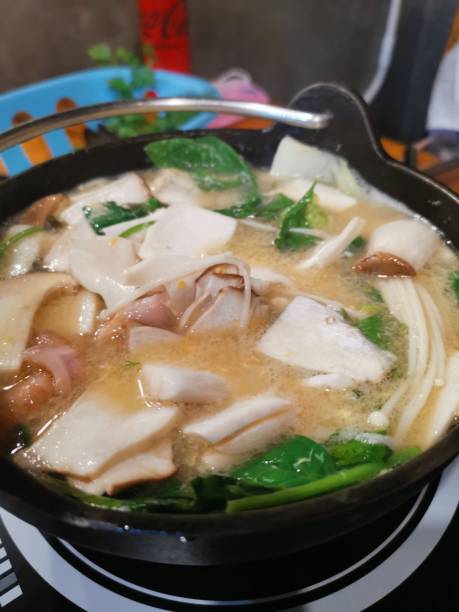 istock Mushroom and sliced pork in dipping sauce pot 1476747830