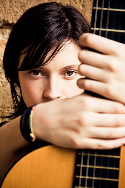 istock Woman holding guitar 147674813