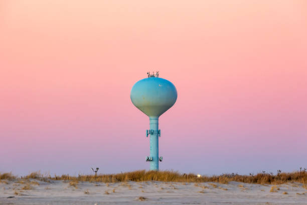 istock A sphere water tower on a beach under a pink cotton candy sunset sky 1476748857