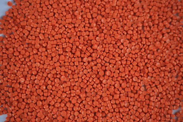 istock Orange plastic pellets background. Close-up plastic granules polymer. Orange plastic beads resin polymer pallet petrochemical 3d illustration. 1476752036