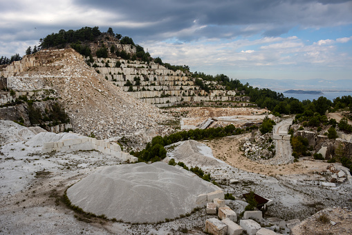 Marble mining plant at the east of the island. White stone in blocks and gravel. Seaside of the Thracian sea. Porto Vathy, island Thassos (Thasos), Greece.