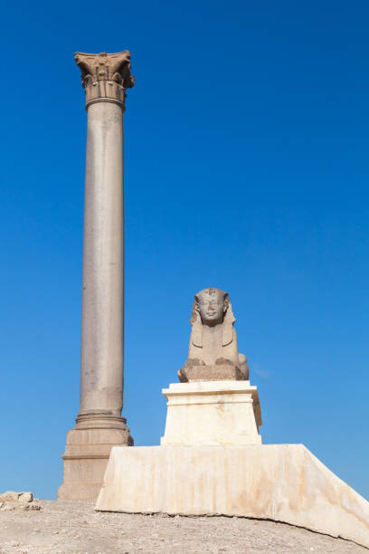 istock Ancient Egyptian Sphinx statue with Pompeys Pillar on a background 1476753767