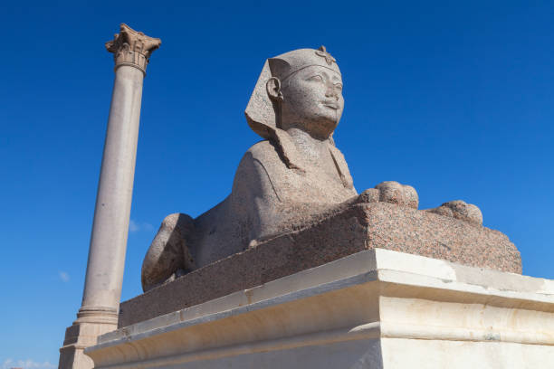 istock Ancient stone sphinx with Pompeys Pillar on a background. Alexandria 1476753771