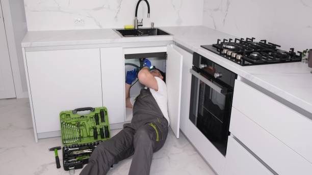 istock A plumber fixes a sink for washing dishes, professional plumbing services 1476753933
