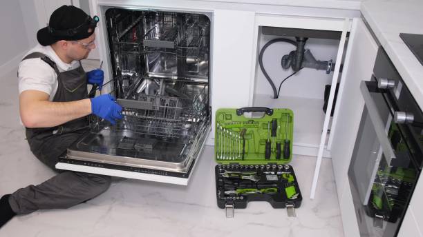 istock A plumber repairs a dishwasher in a kitchen room. Plumbing services 1476753957