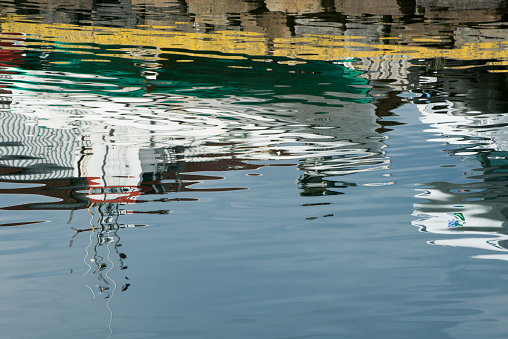 Nautical vessels reflected on water. Iceland. Europe