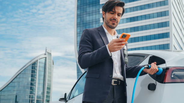istock Businessman charging an electric car 1476754077