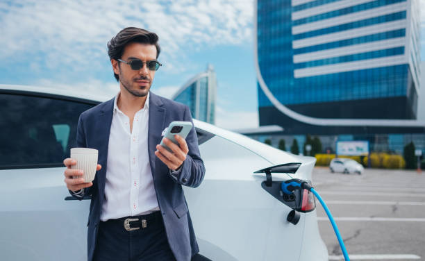 istock Businessman charging an electric car 1476754217