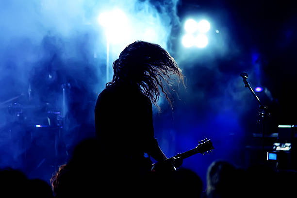 A guitar player in action in a gig stock photo