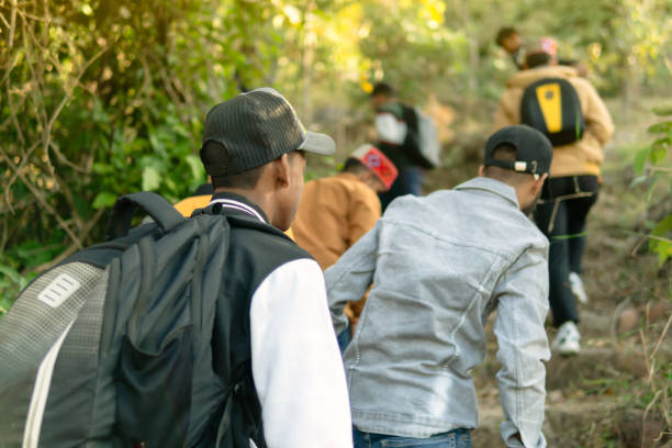 istock Group of people tracking in a mountain forest. 1476755484