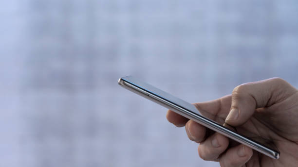 closeup of a male hand using smartphone. - paedophilia imagens e fotografias de stock