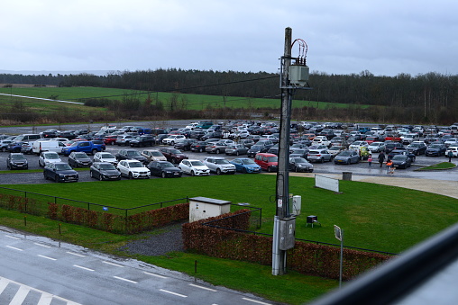 Durbuy, Walloon region, Belgium - March 26, 2023: tourists leaving parked cars on a Sunday in Adventure Valley parking 1