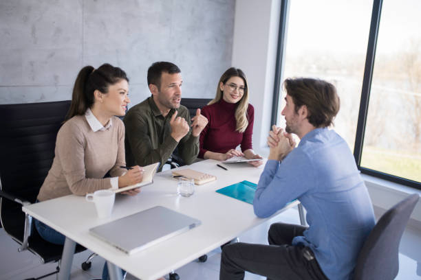 istock Human resource team talking with young man on a job interview. 1476757433