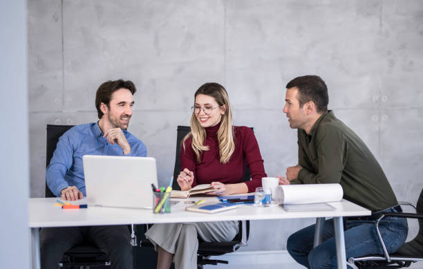 istock Happy business team working together in the office. 1476758961