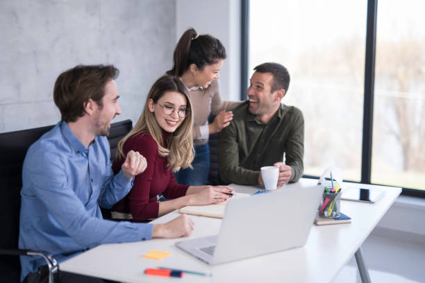 istock Happy business team working together in the office. 1476759064