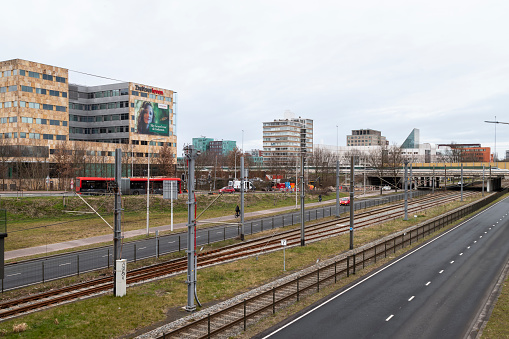 Amstelveen, Netherlands, March 16, 2023; Traffic road and Metro track along office buildings and apartments in Amstelveen.