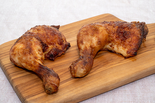 Chicken legs on a wooden cutting board