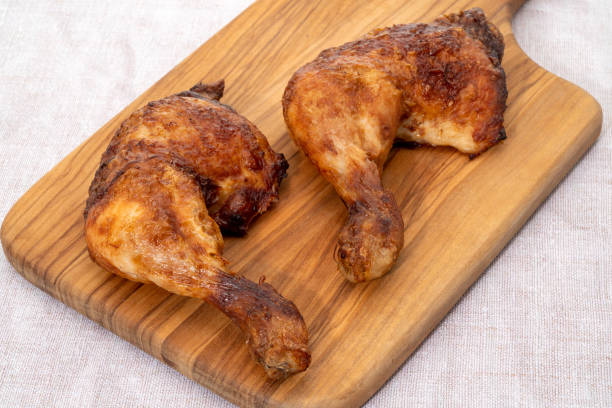 istock Chicken legs on a wooden board 1476760108