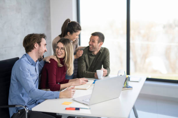 istock Happy business team working together in the office. 1476761237