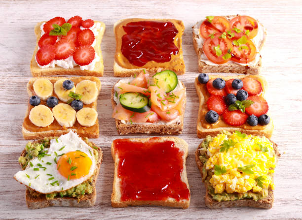 istock Selection of breakfast toasts with different toppings - savory and sweet. 1476762483