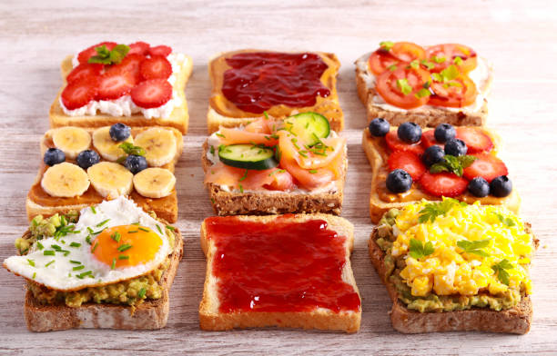 istock Selection of breakfast toasts with different toppings - savory and sweet. 1476762531