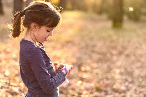 istock Happy girl using smart watch in nature 1476762558