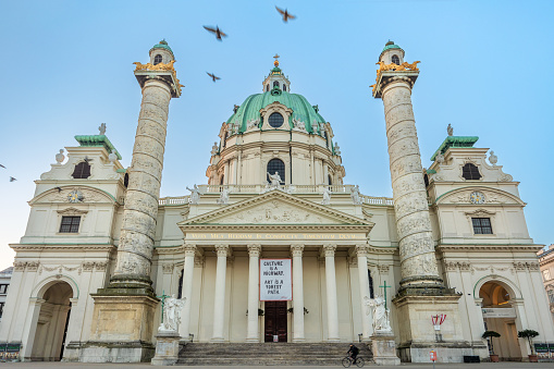 Wide angle view of baroque facade of St Charles Church in Vienna with two spiral columns completed in 1737 - one of the most visited tourist sites of the Austrian capital