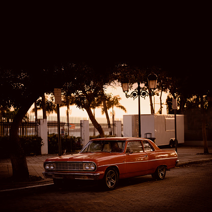 Vintage american car parked at Paseo de La Princesa -walkway in Old San Juan, Puerto Rico