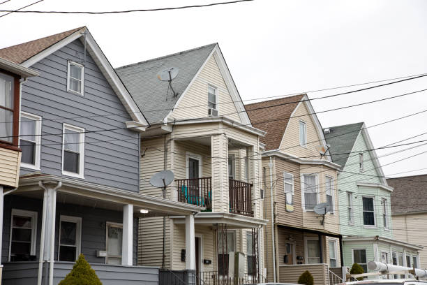 Inner city neighborhood homes with satellite dishes Inter city homes crowded together on a rainy overcast day. run down neighborhood stock pictures, royalty-free photos & images