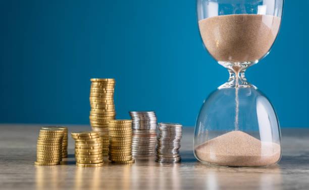 istock Coins and hourglass 1476769797