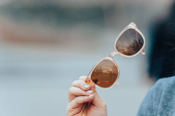 istock Holding sunglasses in hand 1476769810