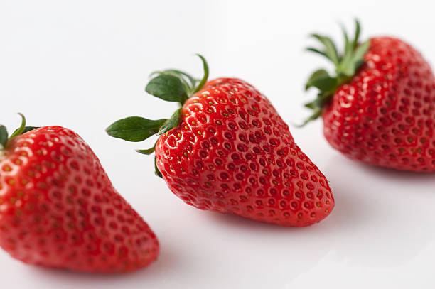 Three lovely strawberries stock photo