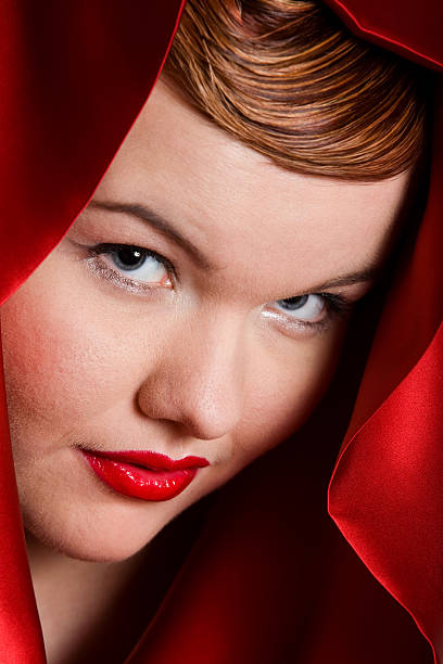 Close up portrait of woman in red hood stock photo