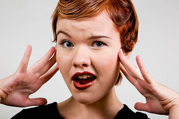 Lovely red-head young woman with surprised look stock photo