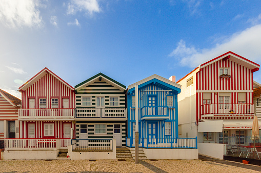 Aveiro, Portugal - December 13, 2018: striped colorful houses on a sunny day at the Praia da Costa Nova ( New Coast Beach ) in the city of Aveiro, Portugal.