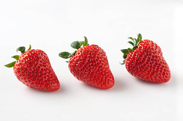 Three strawberries stock photo