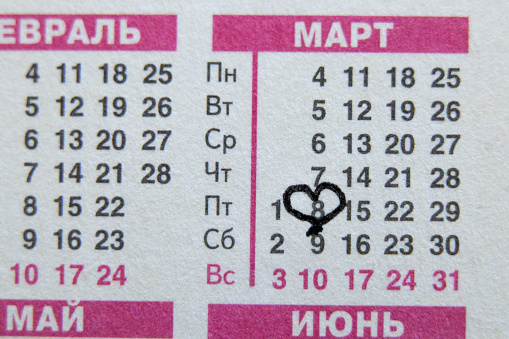 Russian printed calendar with circled March 8 as background on the sheet, calendar