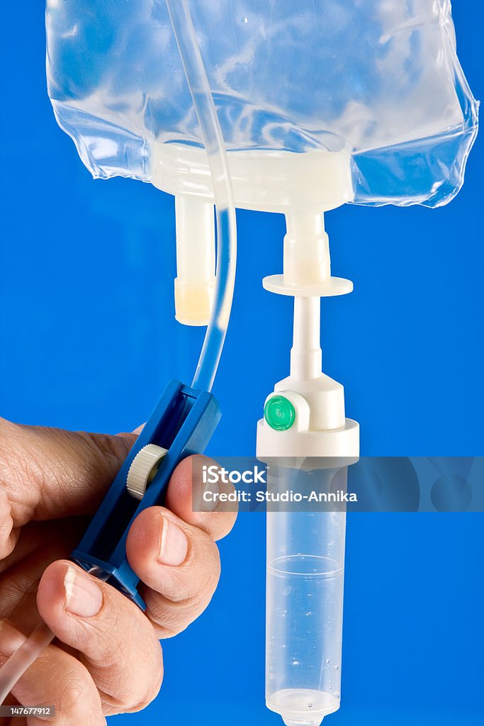 Regulating an IV drip Nurse's hands regulation an IV drip in hospital Chemotherapy Drug Stock Photo