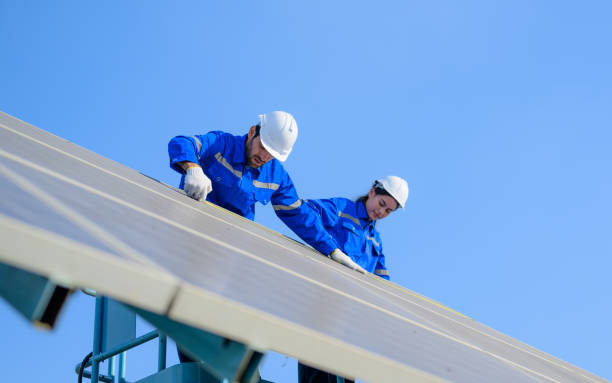 istock Technicians workers team installing solar panels at industrial solar cell farm 1476779378