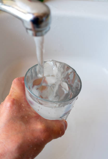 istock Filling a glass with tap water. 1476784263