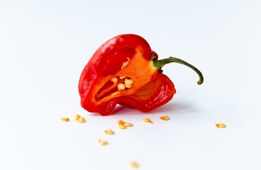 A half cut red Habanero chilli pepper isolated in white.