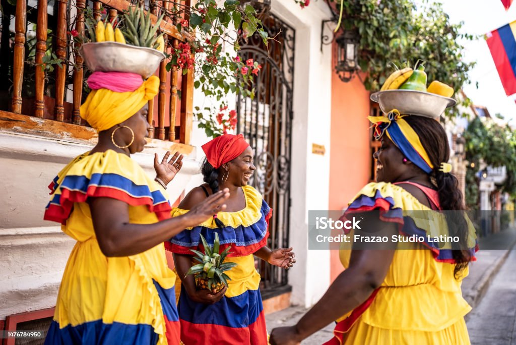 Palenqueras having fun while talking on the street in Cartagena, Colombia Colombia Stock Photo
