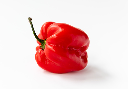 A whole red Habanero chilli pepper isolated in white.