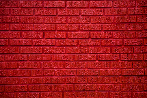 Vibrant red brick wall background.