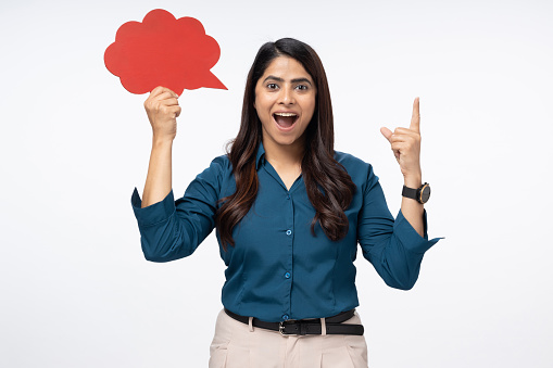 Portrait of pretty cheerful young businesswoman holding in hand board copy empty blank space information on white background