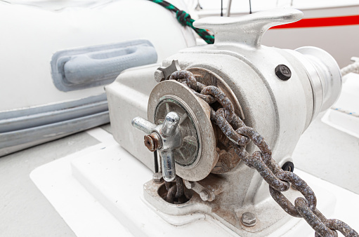 Anchor winch with a chain on a yacht, close-up.