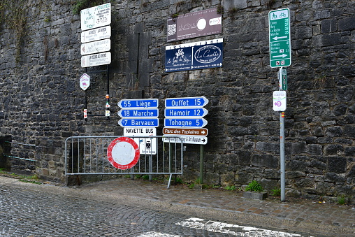 Durbuy, province of Luxembourg, Belgium- March 26, 2023: white text  blue background text, official road signs in Belgium. Liège, Marche, Barvaux Ouffet Harmoir, Tohogne. direction signs. Shuttle bus to rail station sign