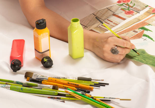 istock Woman's hand holding art brushes 1476793908